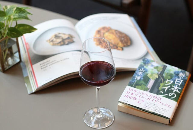 テーブルの上の本とワイングラス