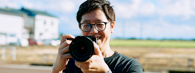 趣味のカメラを手にする武田修美さん