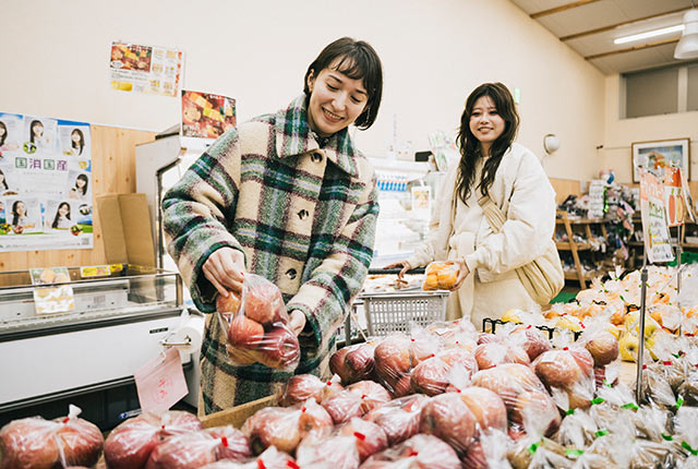 袋詰めされたリンゴやみかん、レモンなどが並ぶ